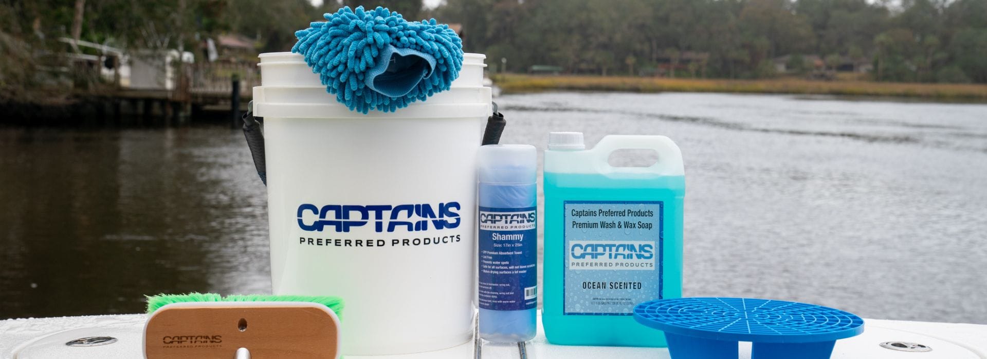 Boat cleaning supplies on the transom of a boat while docked in the water.