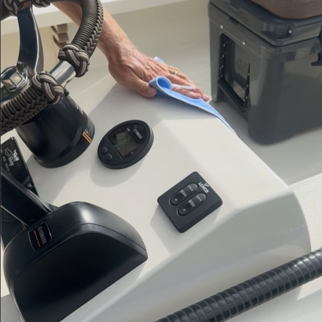 Applying Captain's Fury Quick Detailer Spray to a skiff boat.