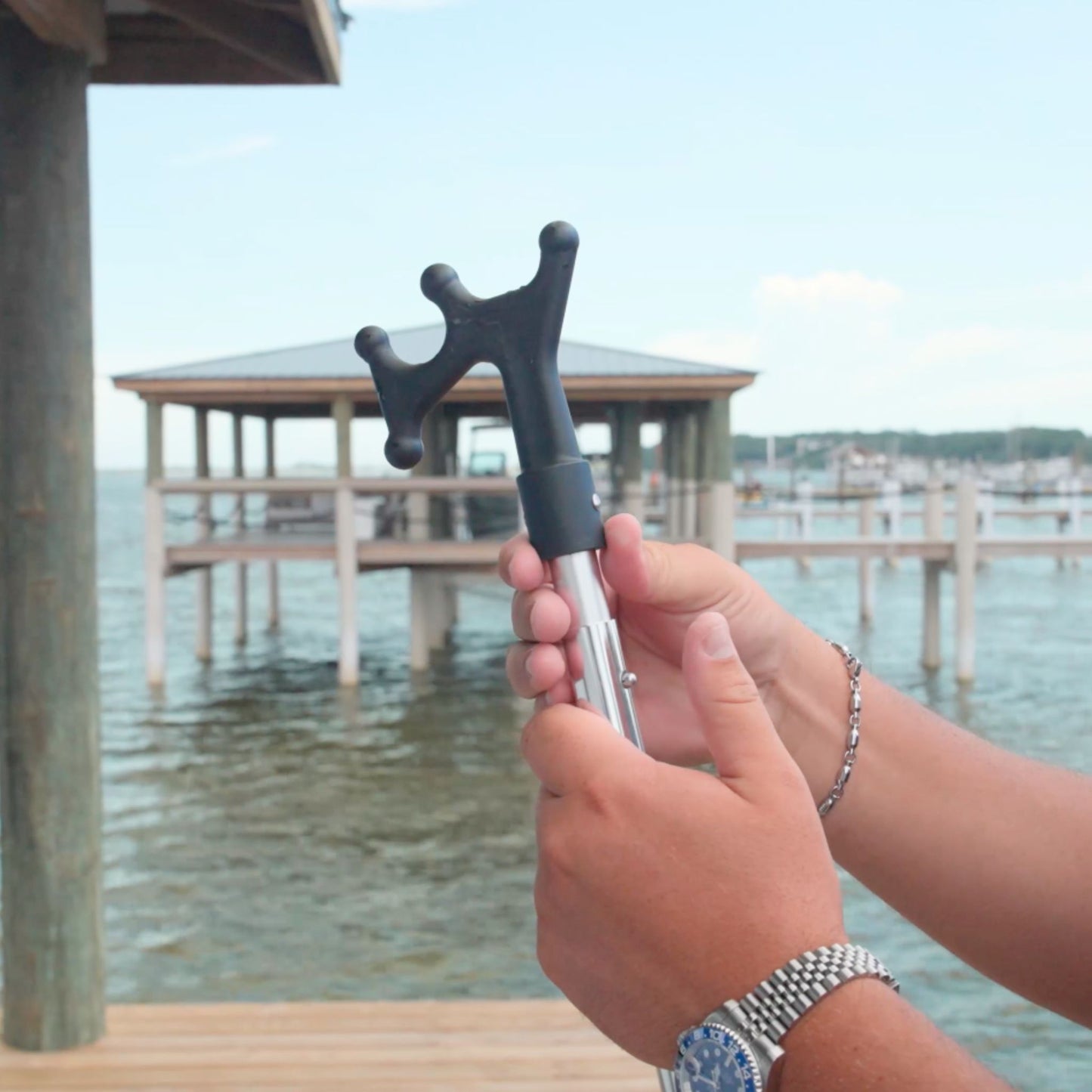 A boat hook attachment on the end of the telescopic handle from Captains Preferred Products.