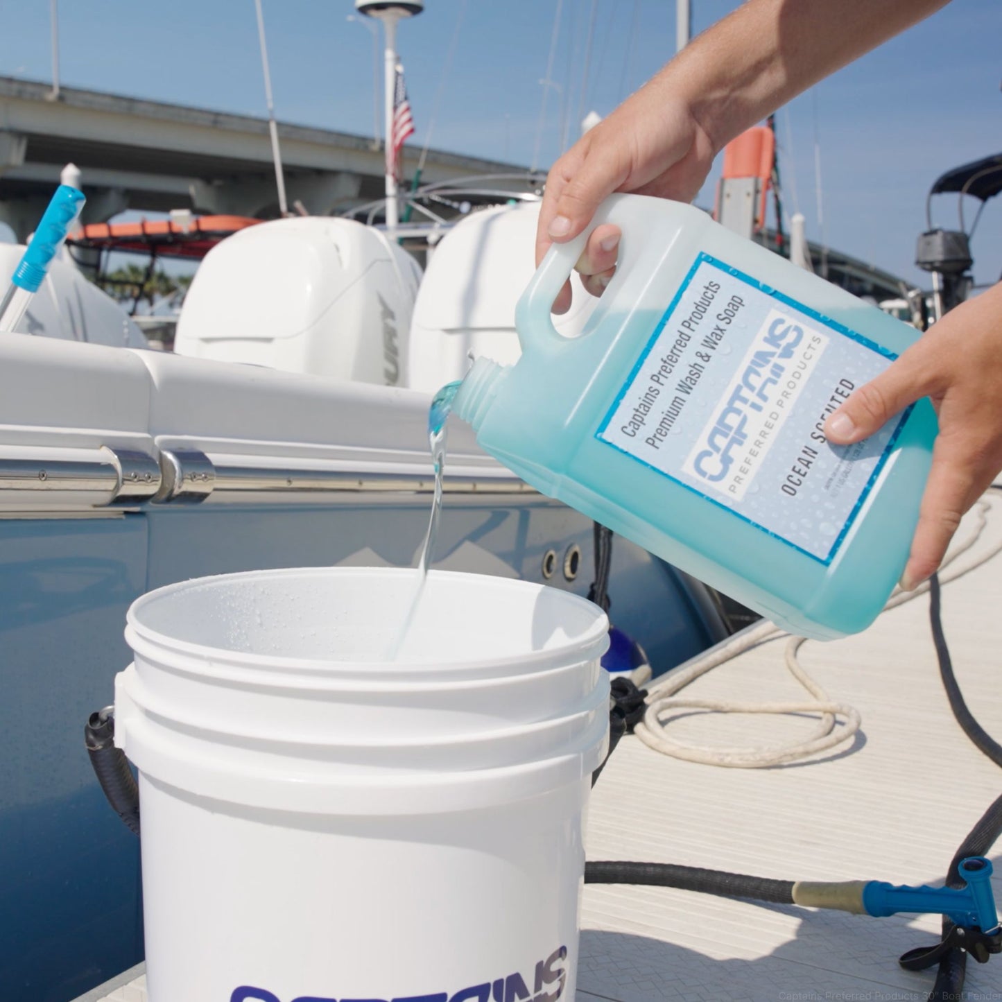 Boat soap being poured into a 5-gallon bucket.