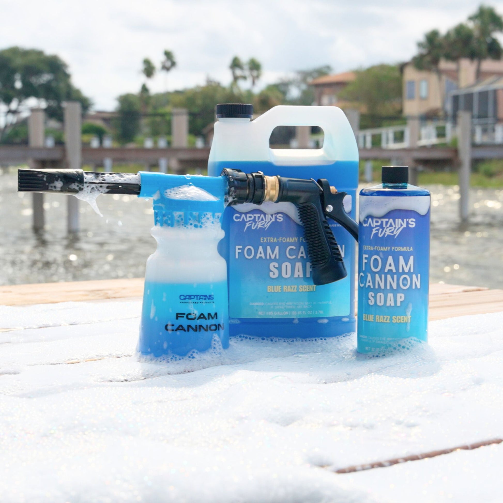A foam cannon with foam cannon soap on a dock covered in thick foam.