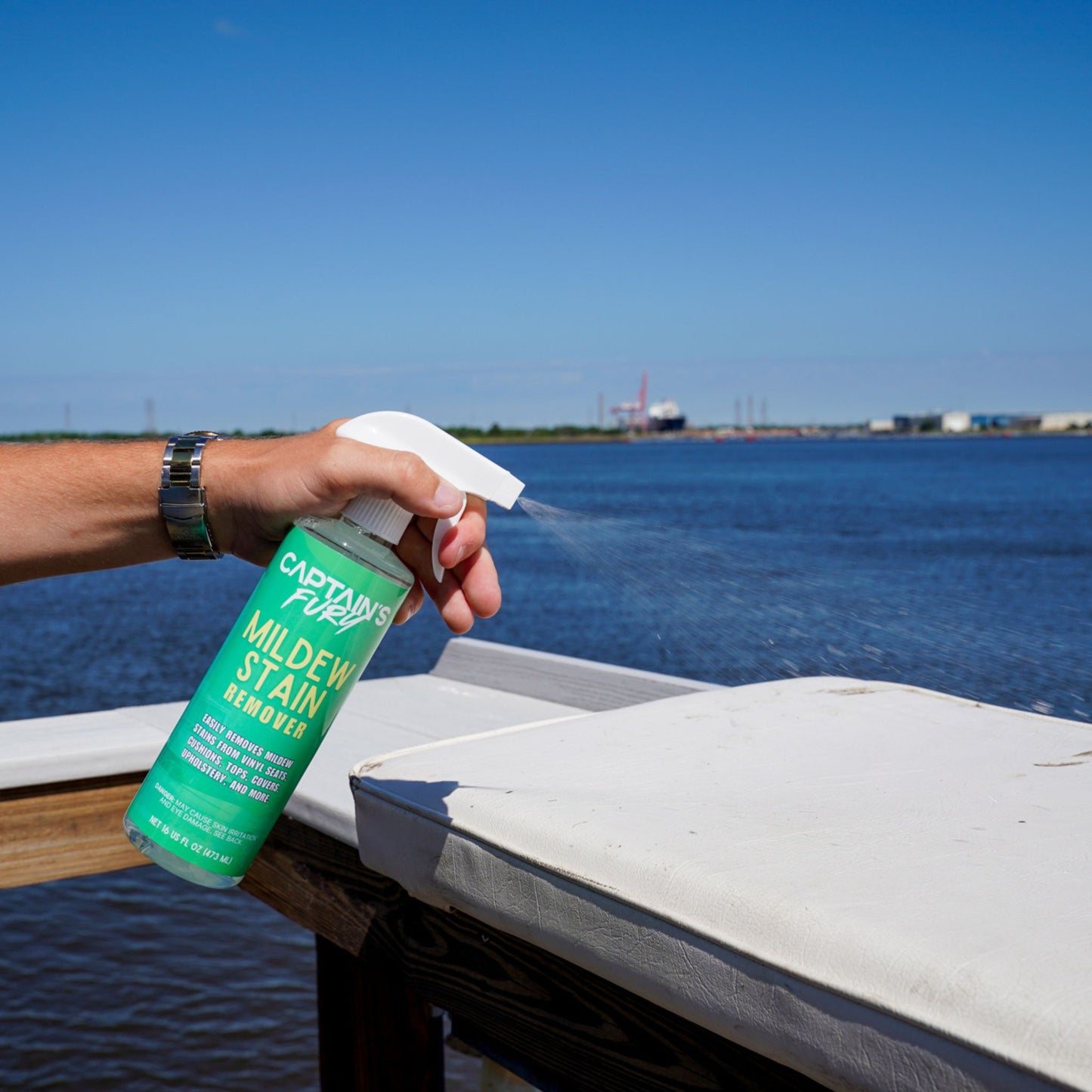Spraying Captain's Fury Mildew Stain Remover.