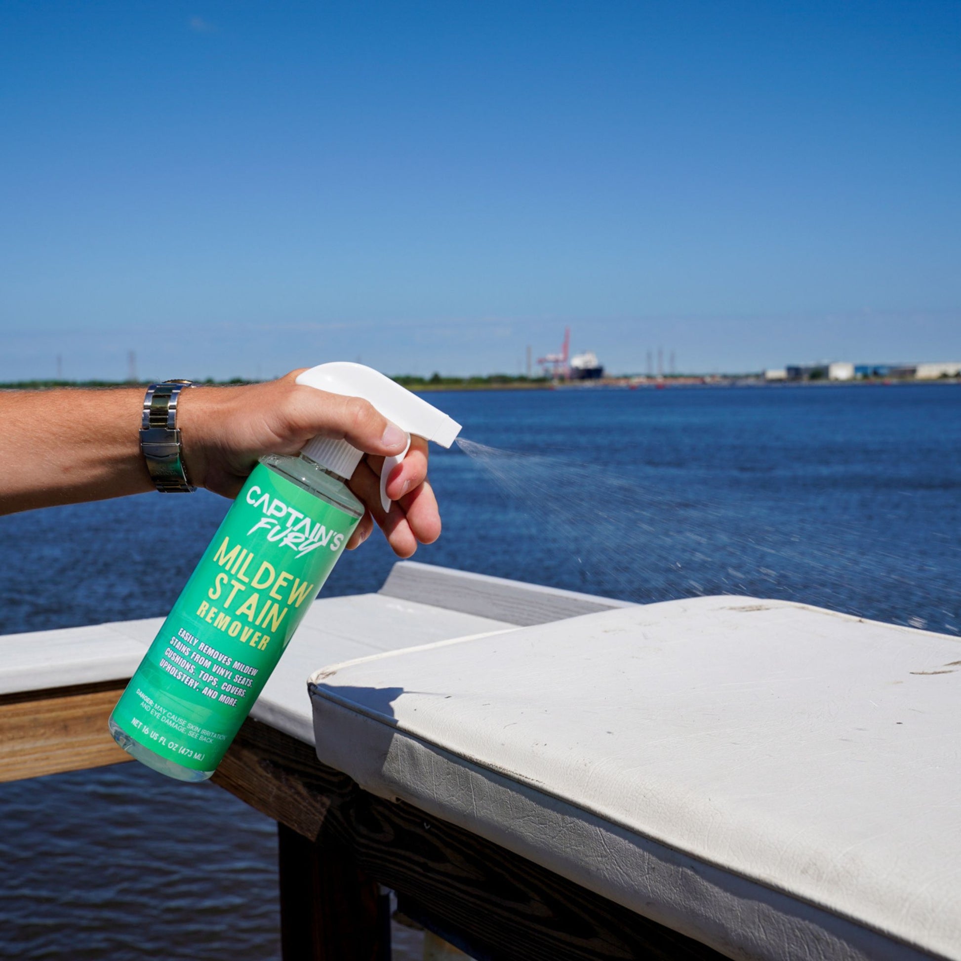 Spraying Captain's Fury Mildew Stain Remover.