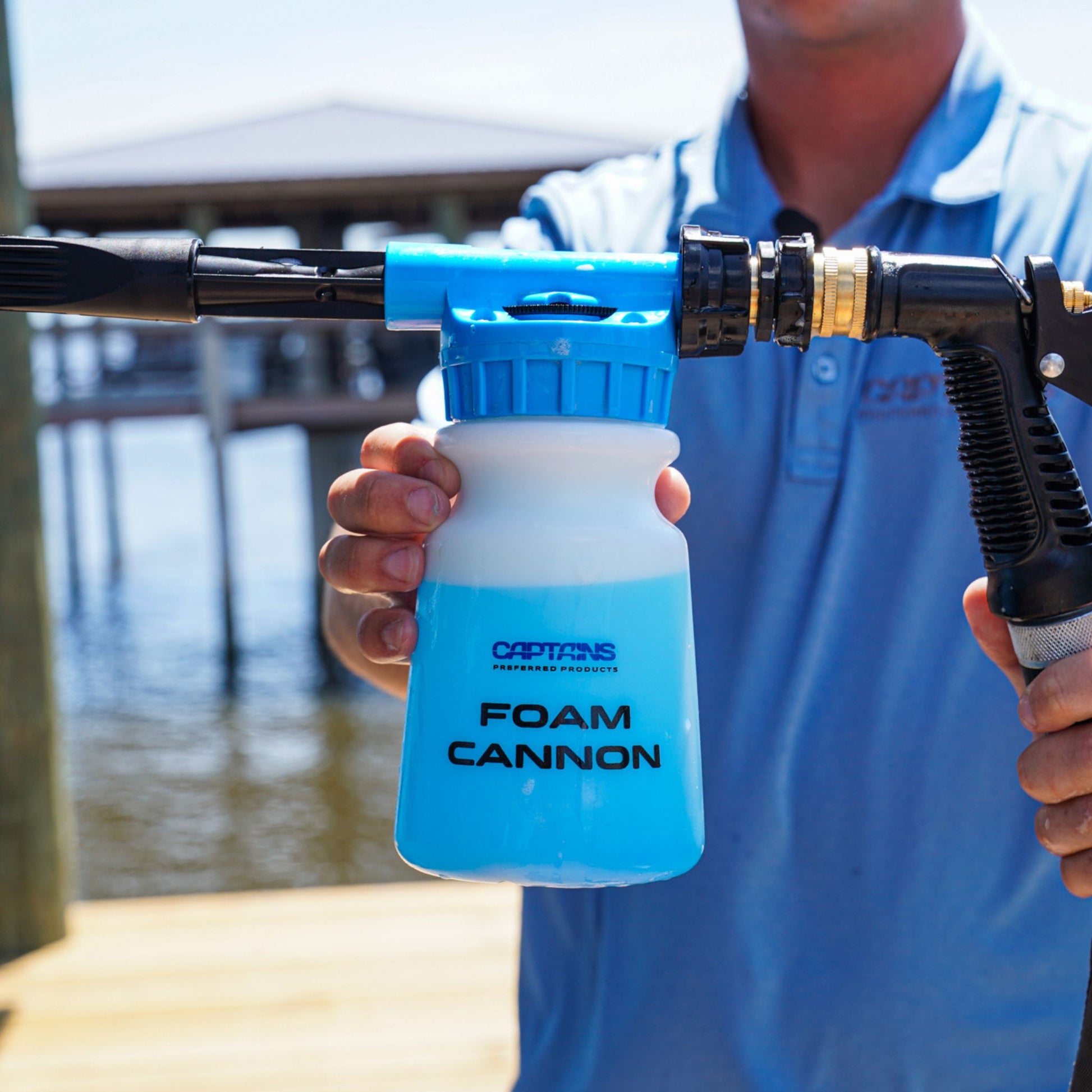 A foam cannon full of blue soap to create thick foam for washing.