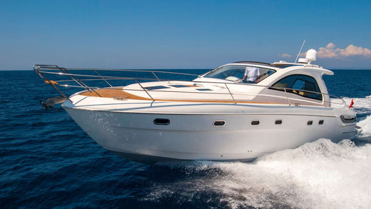 A polished speed boat cutting through the ocean.