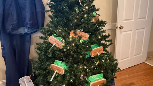 A Christmas tree decorated with green boat brushes and surrounded by marine supplies.