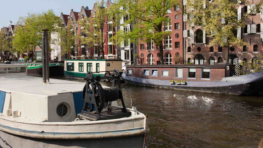 Dutch barge boats in a canal on a sunny day.