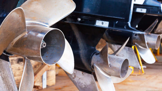 Propellers on a boat that has been taken out of the water.