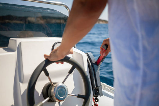 A boat captain driving a boat.