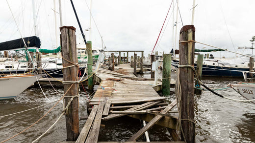 A hurricane wrecked marina with broken docks and damaged boats.