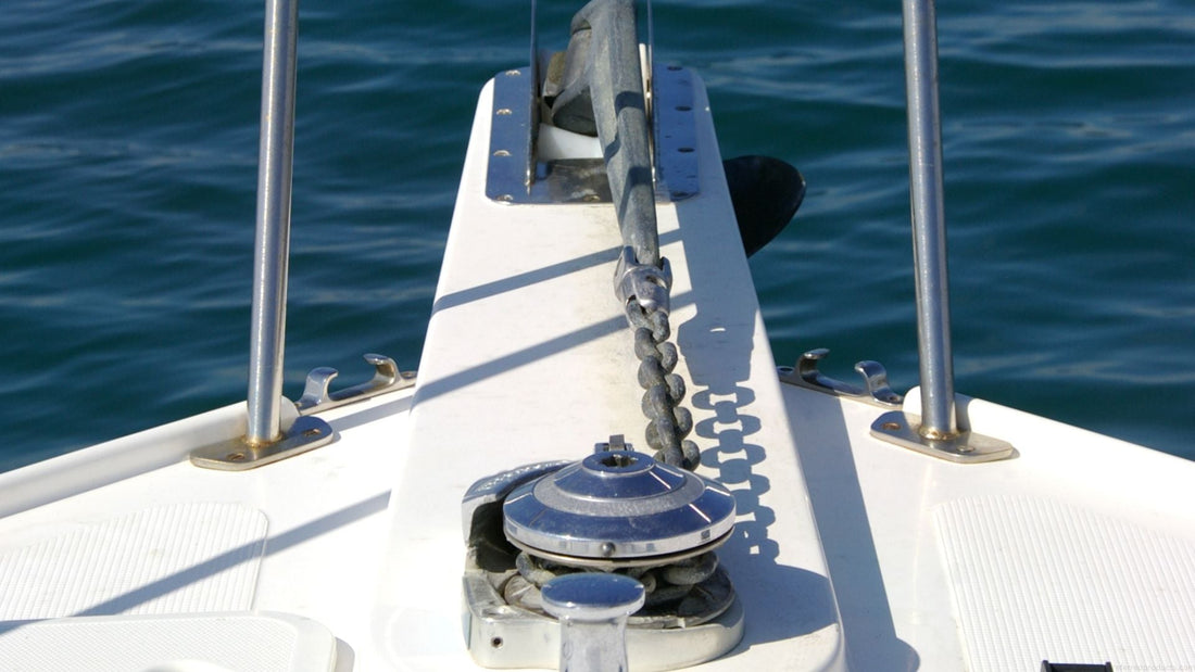 A windlass and anchor at the end of a boat.