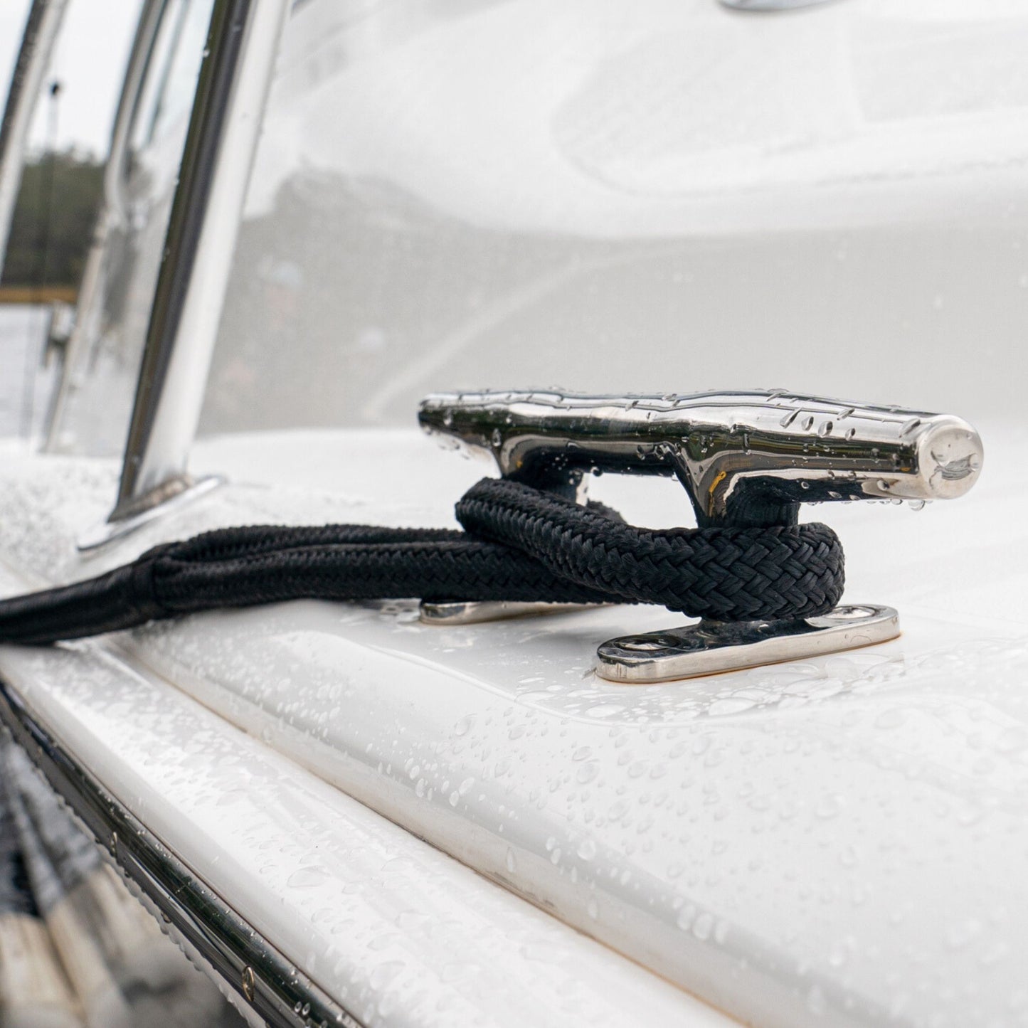 A 3/4" black nylon dock line tied to a boat cleat.