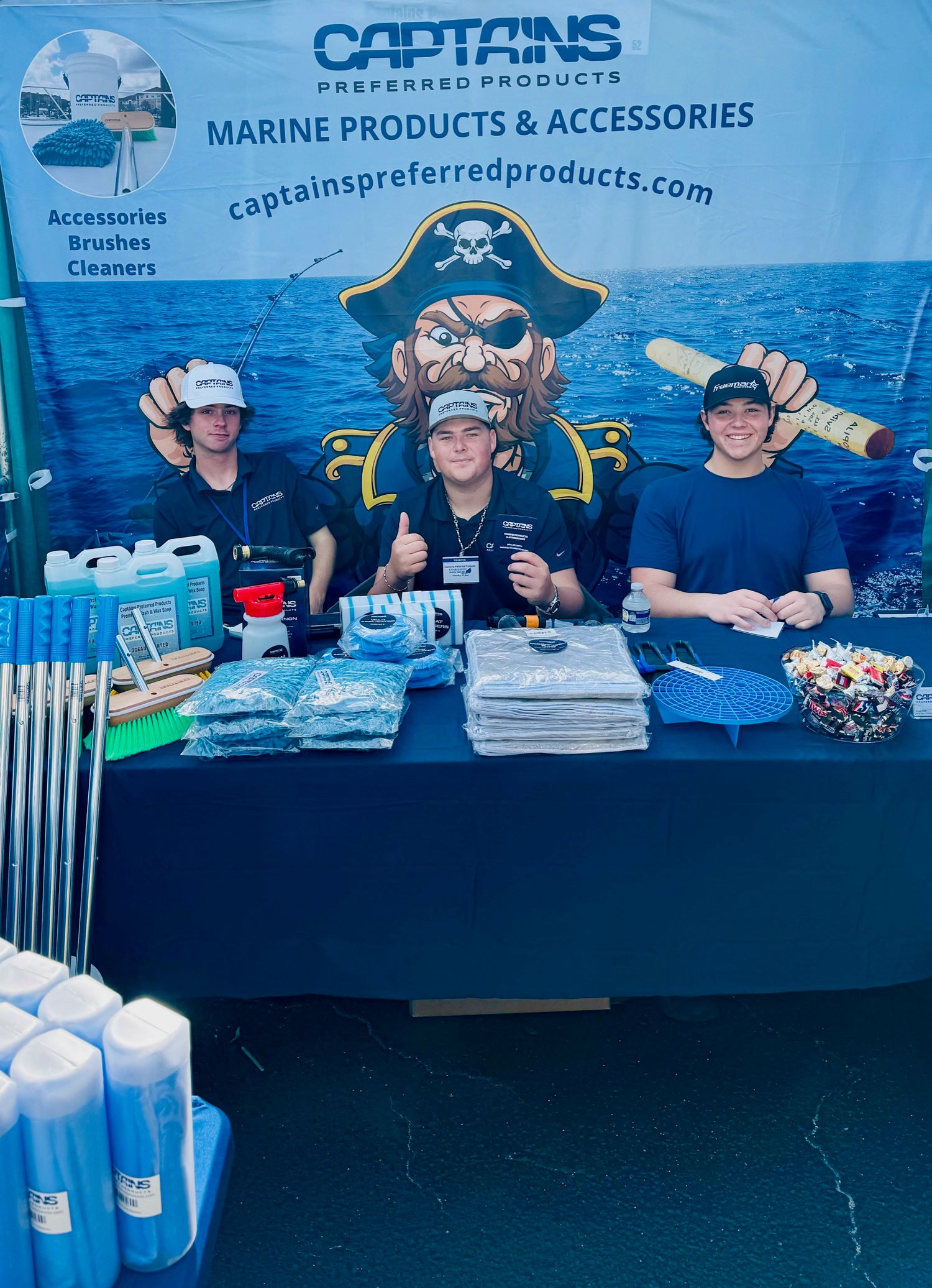 The Captains Preferred Products team sits at a table at the Charleston Boat Show 2024.