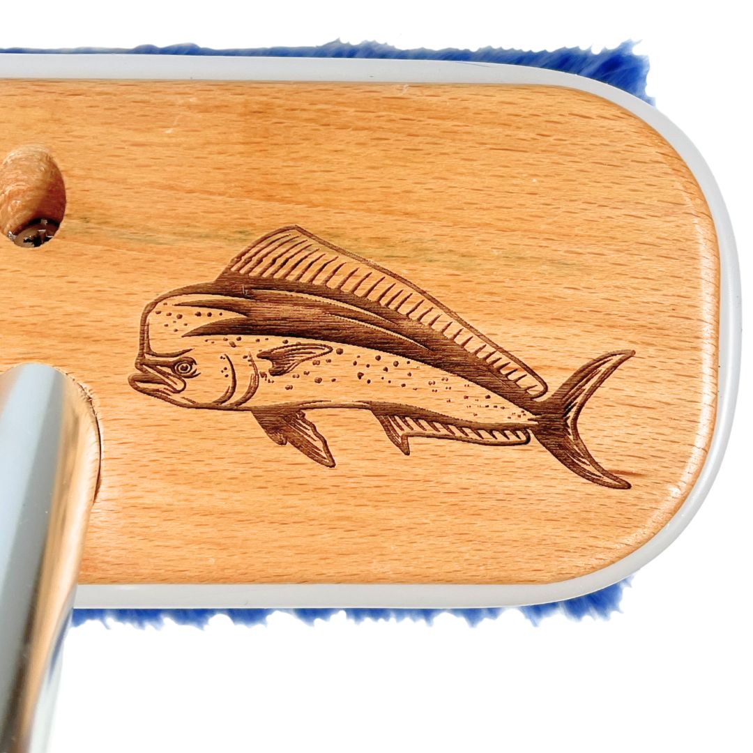 A mahi mahi fish laser-etched into a wooden boat brush.