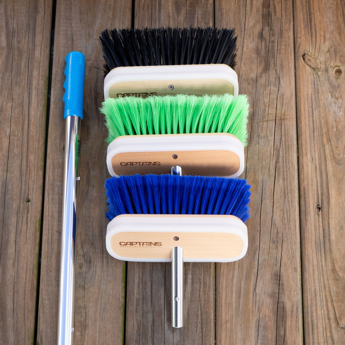 The three boat brush and handle kit from Captains Preferred Products sits on a wooden dock.