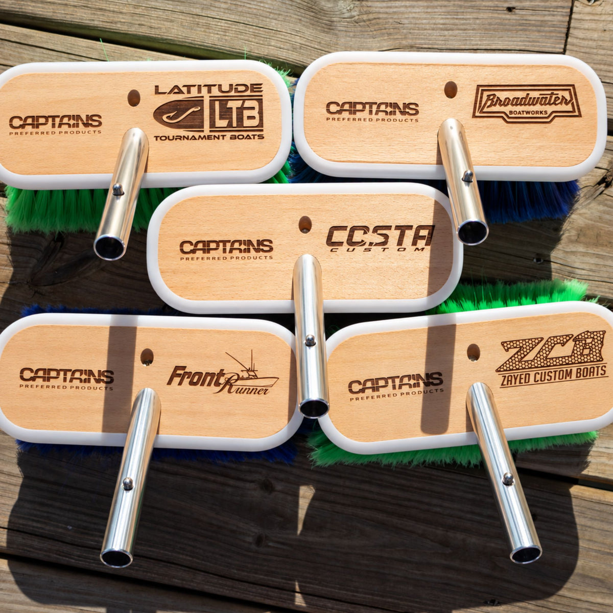 Examples of customized boat brushes with different logos, laser-etched on Captains preferred Products brush heads.