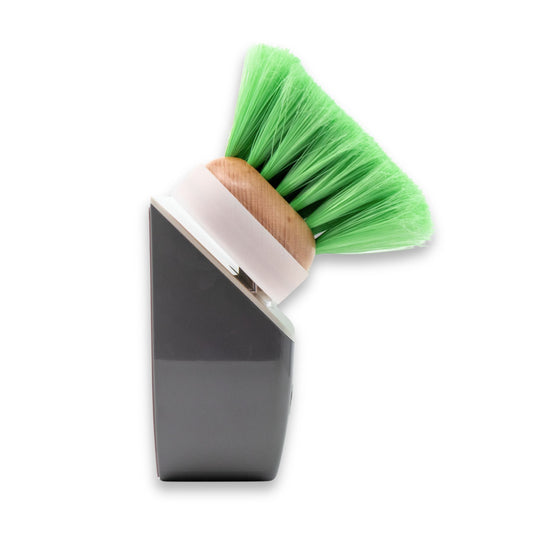 A side view of a TidyBoat brush head organizer holding a green brush head.