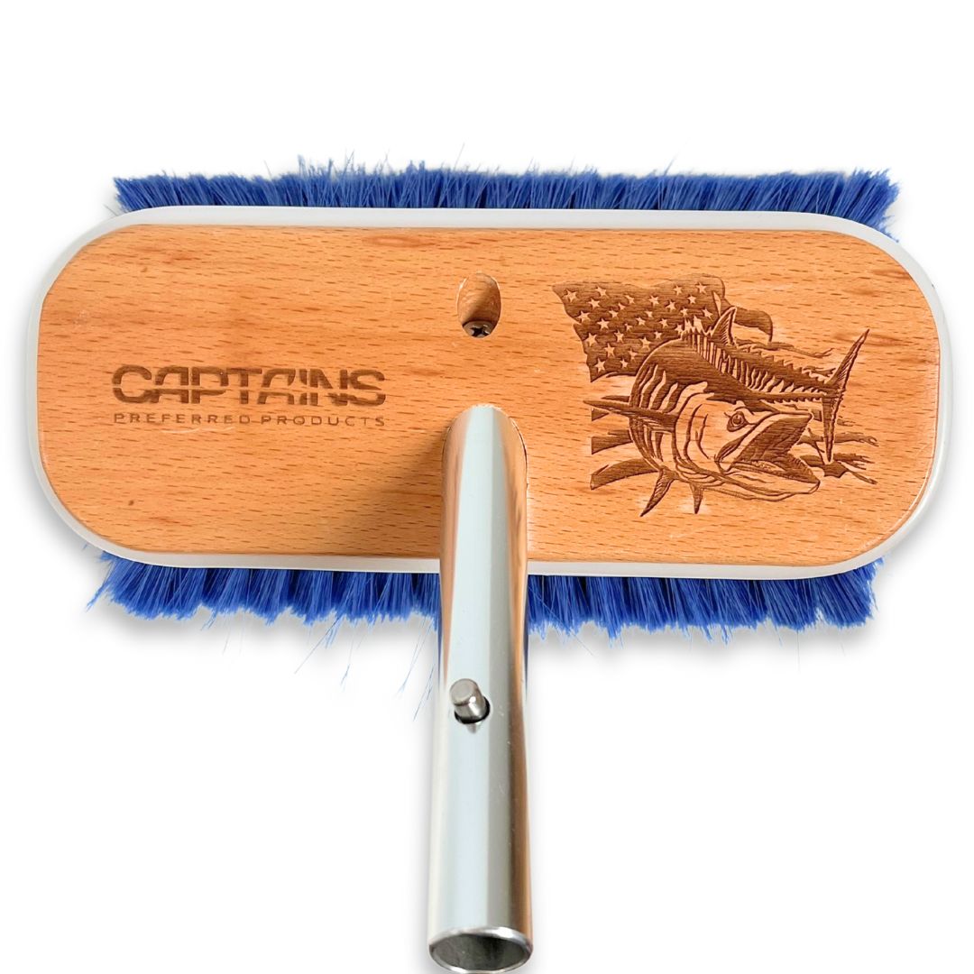 A custom boat brush with a mackerel design etched into the wood.