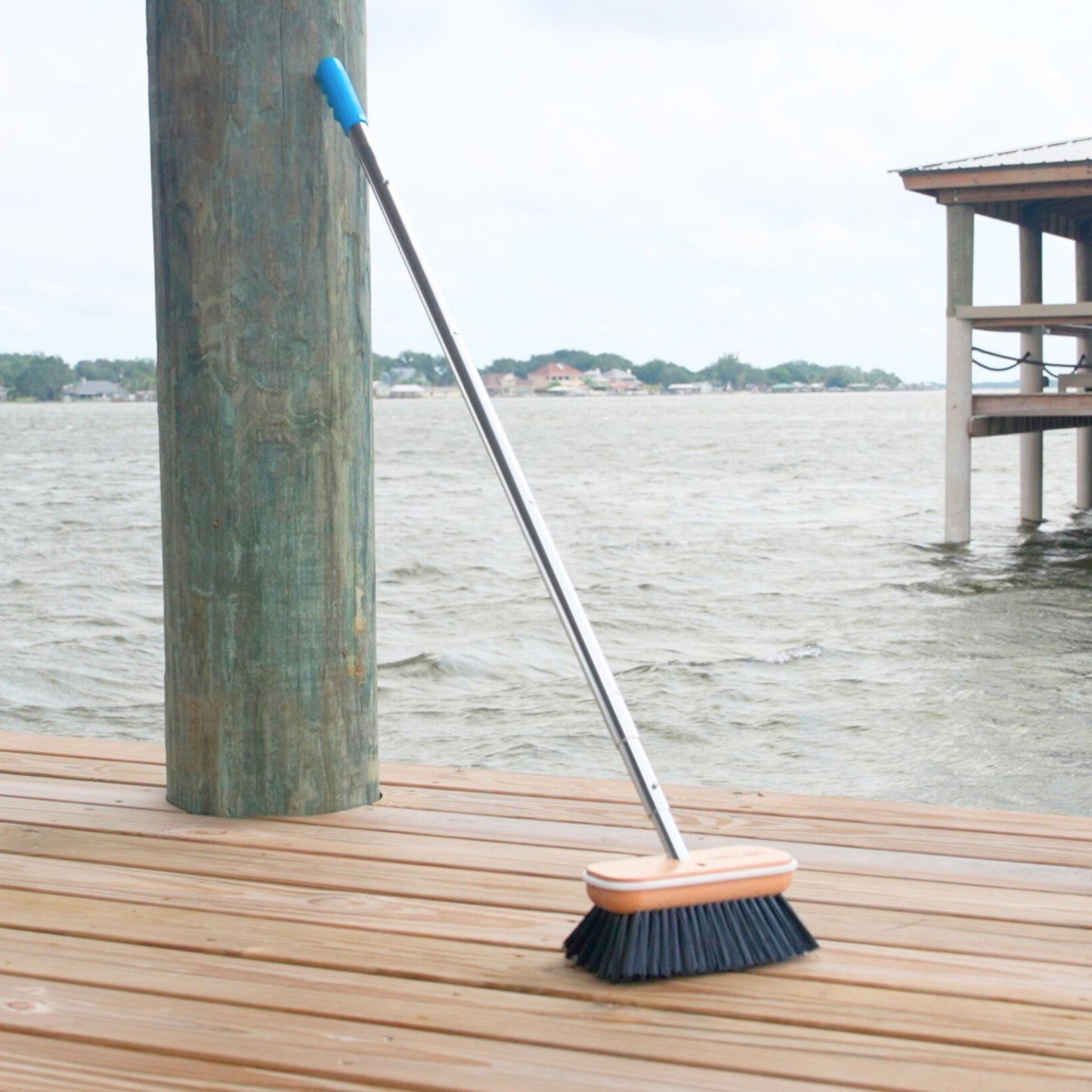 A black Hard boat brush head from Captains Preferred on a 6ft telescoping handle.