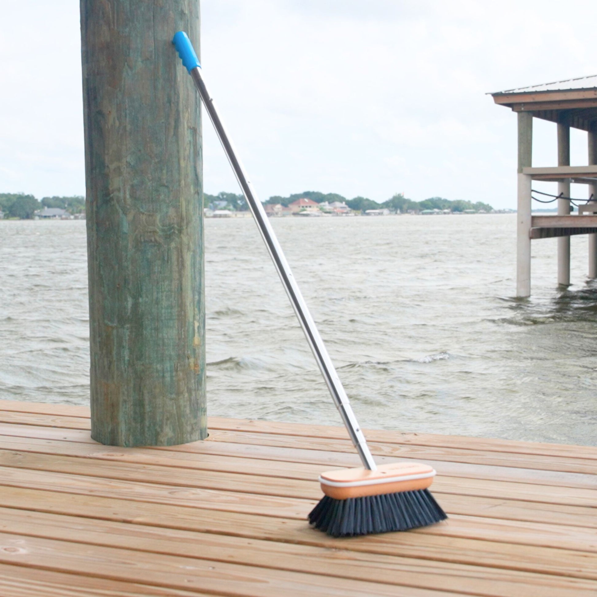 A black Hard boat brush head from Captains Preferred on a 6ft telescoping handle.