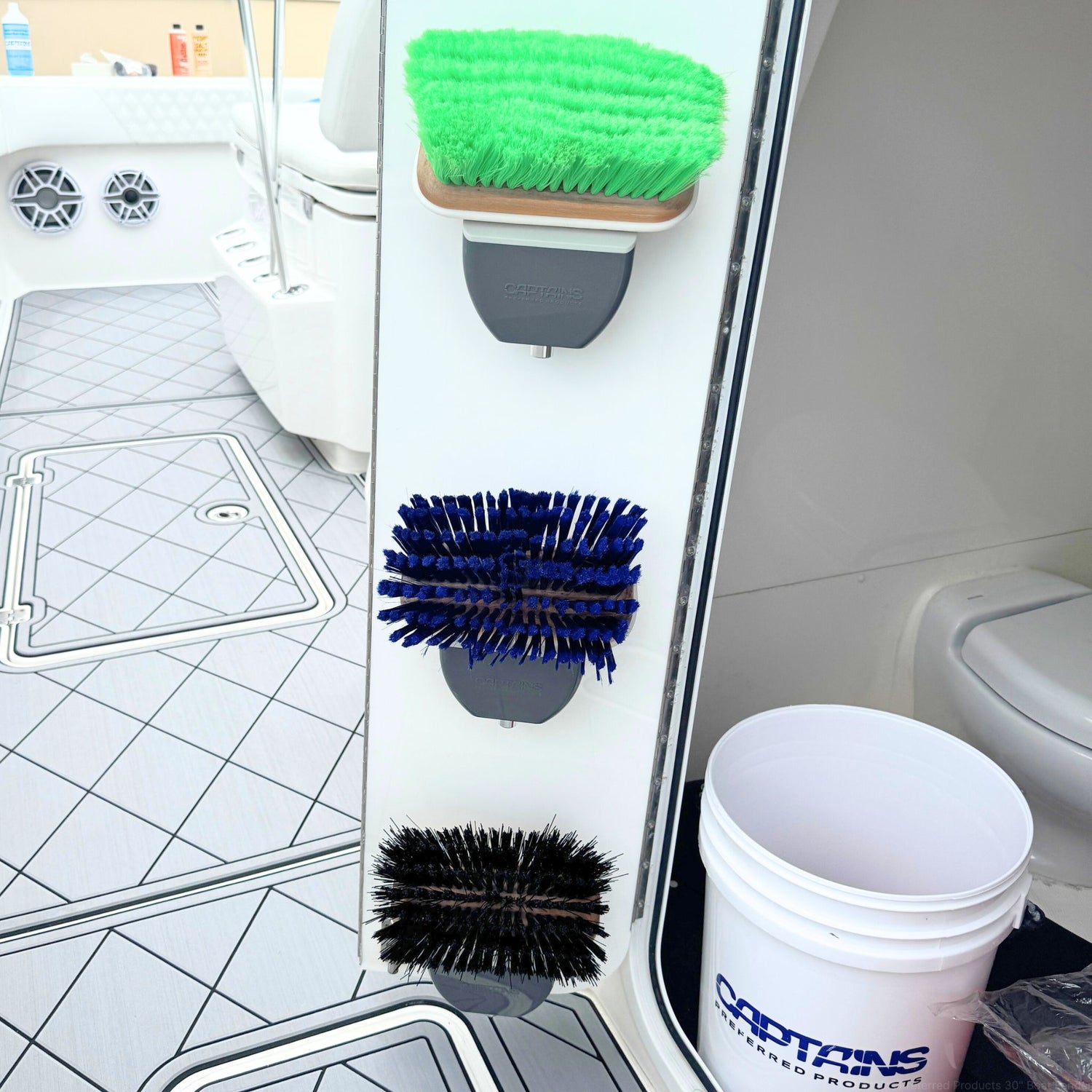 Brush head organizers being used to hold boat brushes on the door of a boat locker.