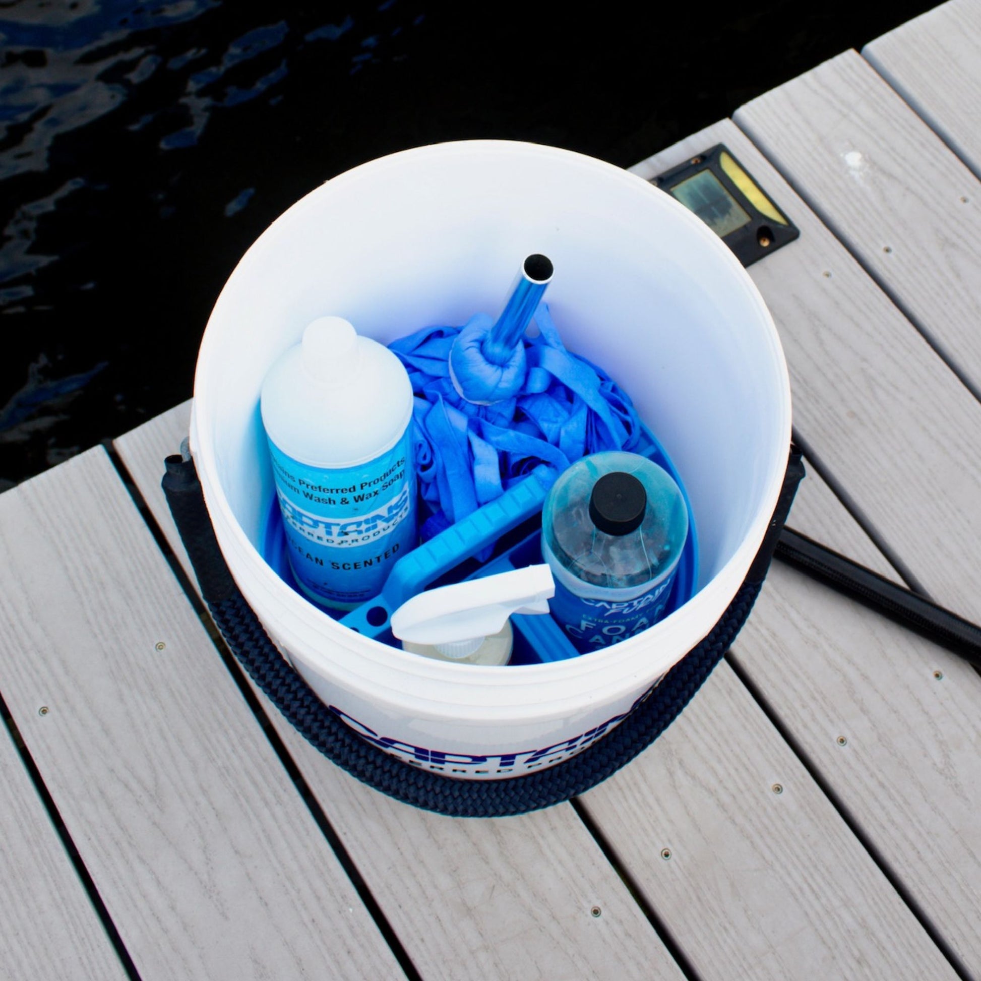 A 5-gallon bucket with a bucket caddy inside holding supplies.