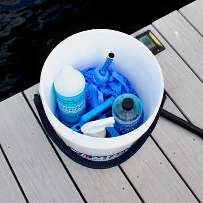 A 5-gallon bucket with a bucket caddy inside holding supplies.