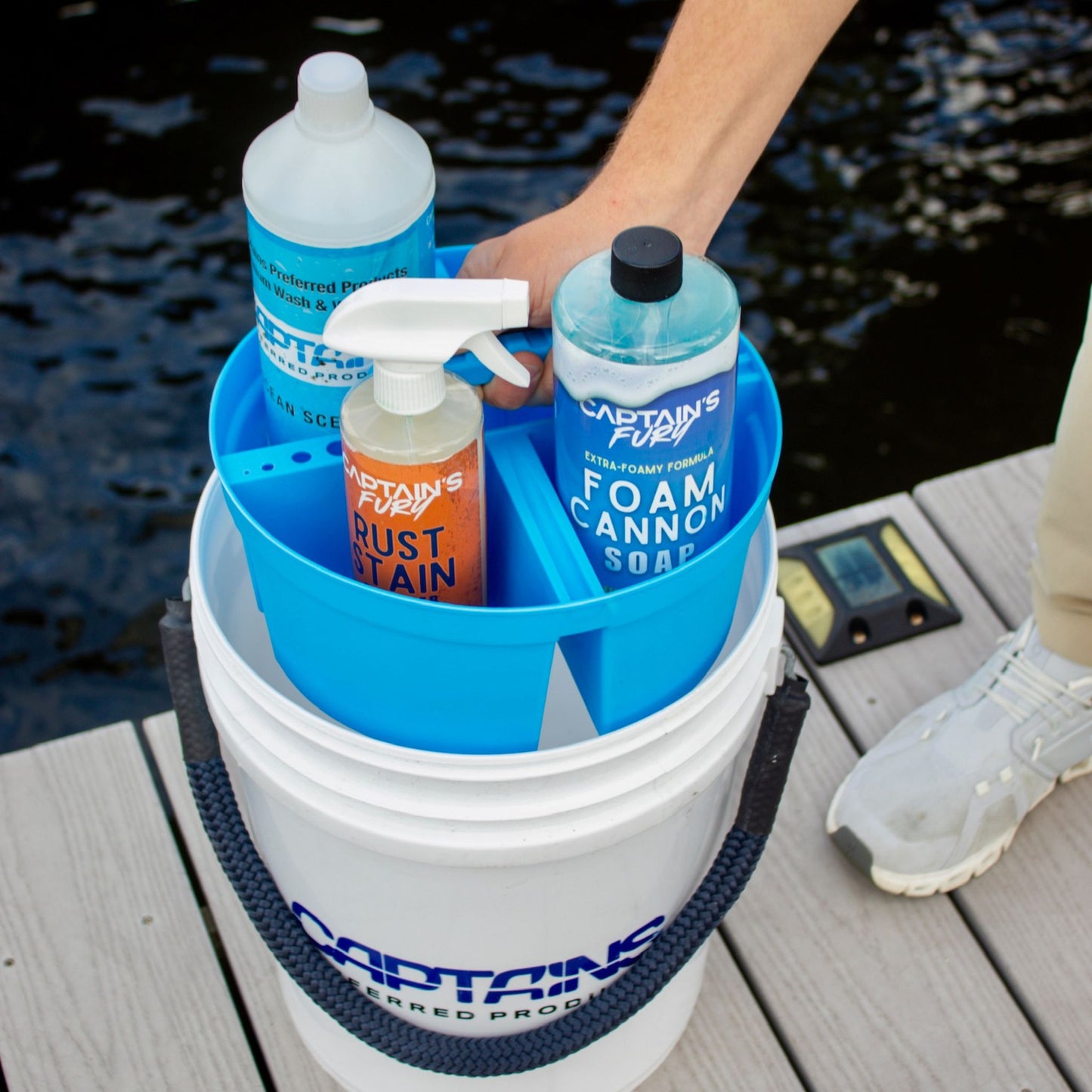 A blue bucket caddy holding boat cleaning supplies.