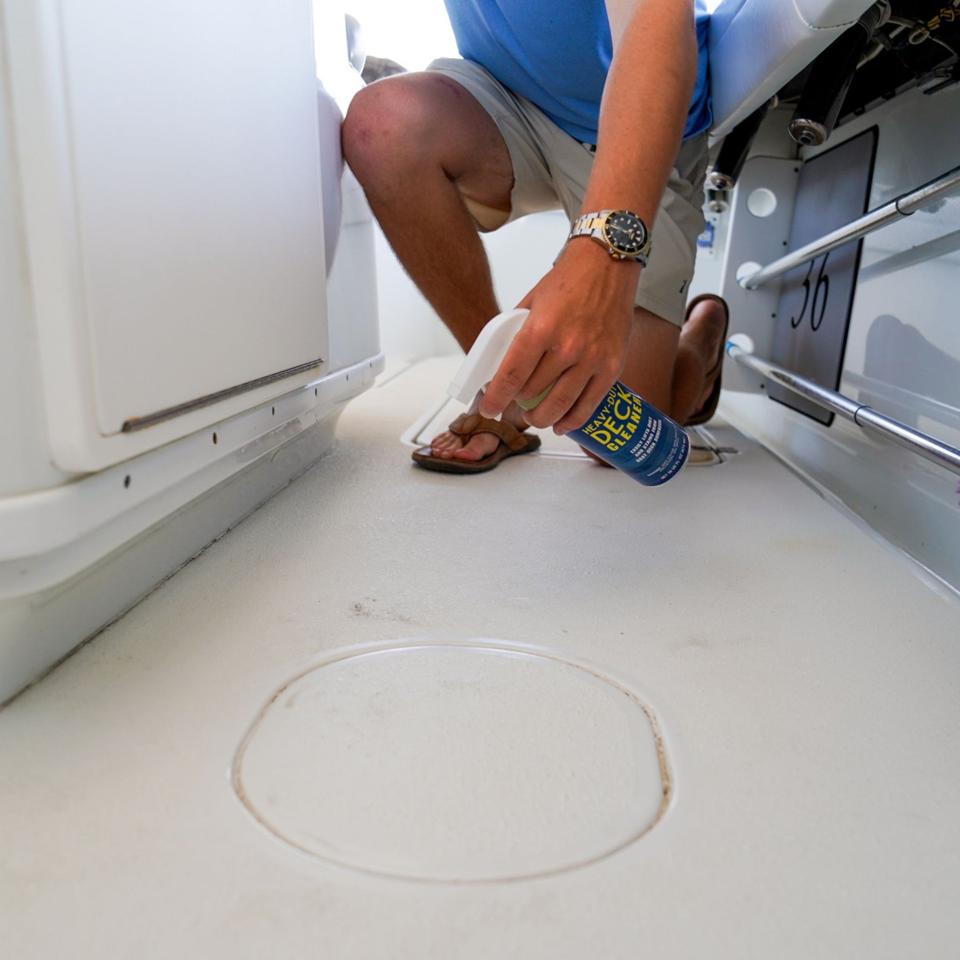 Using Captain's Fury Deck Cleaner on a dirty boat deck.