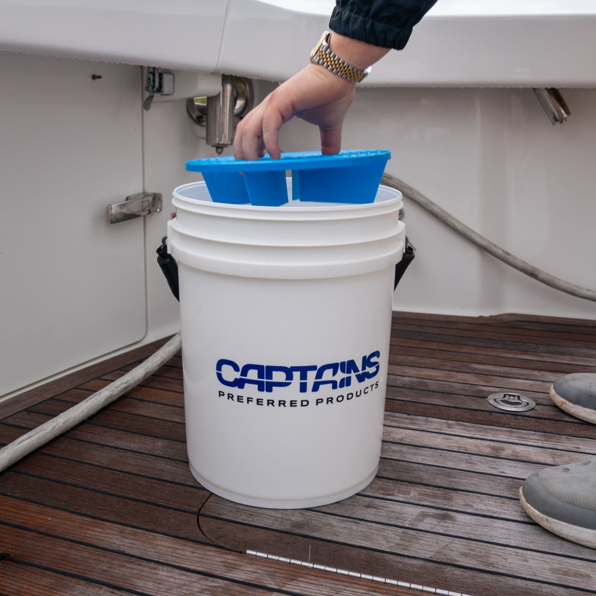 Inserting a bucket guard for grit and dirt into a 5 gallon bucket from Captains Preferred Products.