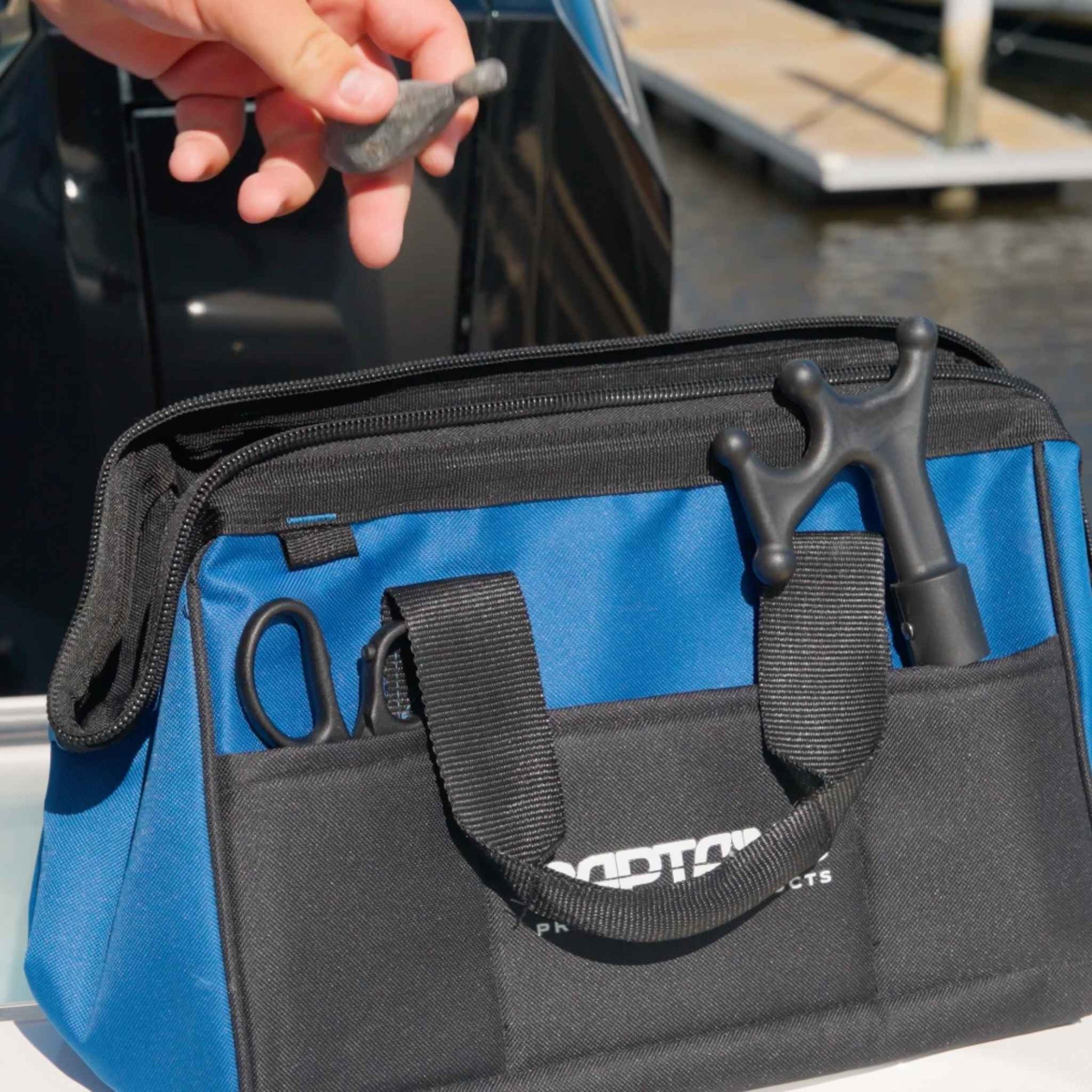 Grabbing a fishing lead from a Captains Preferred bag.