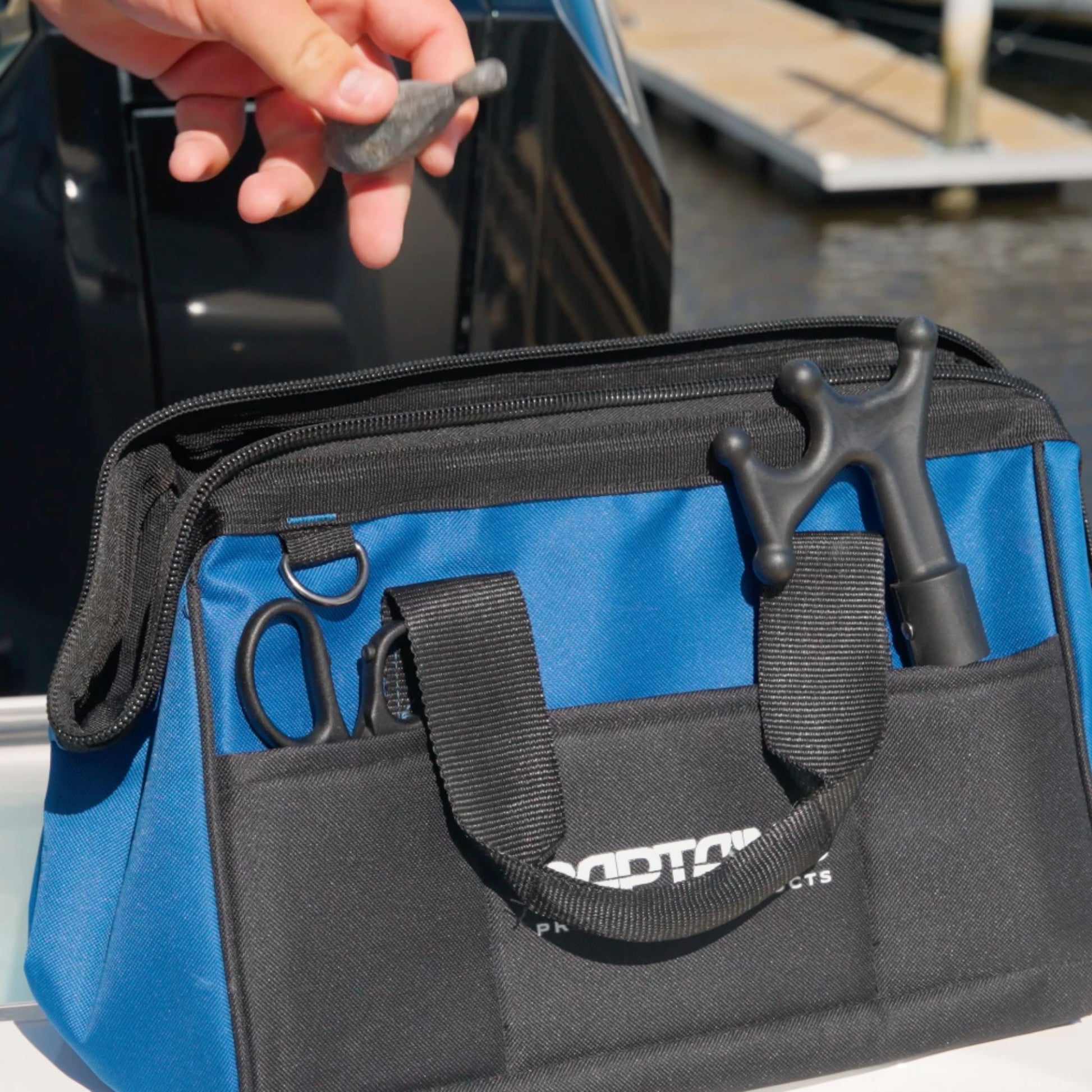 Placing a fishing weight into the Fishing Weight Lead Bag.