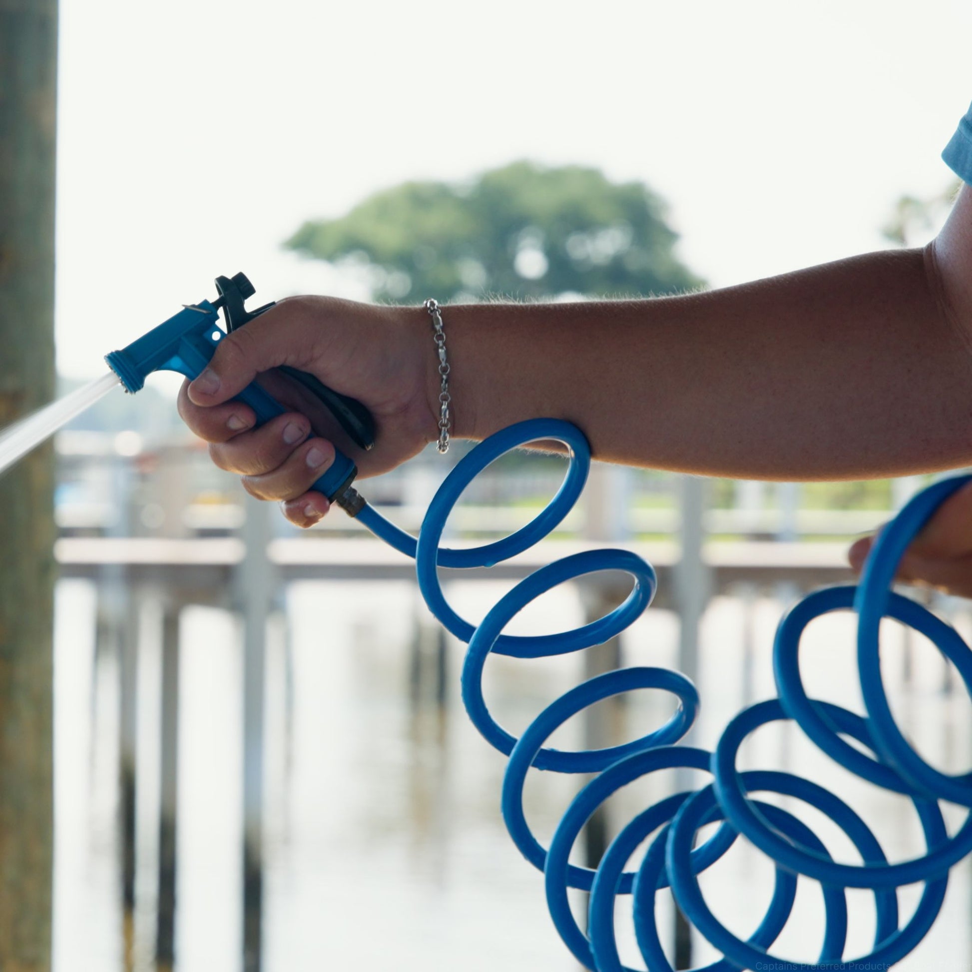 Spraying Captains Preferred Products washdown hose and nozzle for boats.