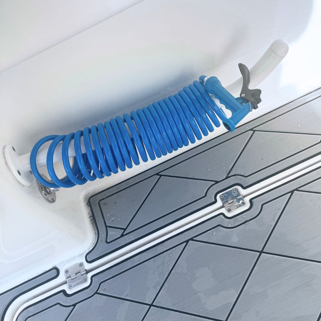 A washdown hose for a boat installed and coiled up neatly.