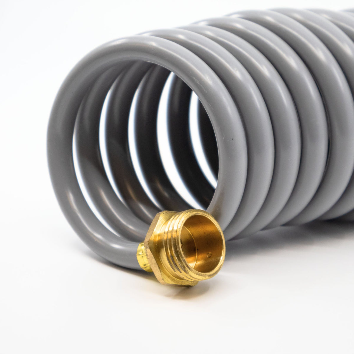 The male end of a gray washdown hose.