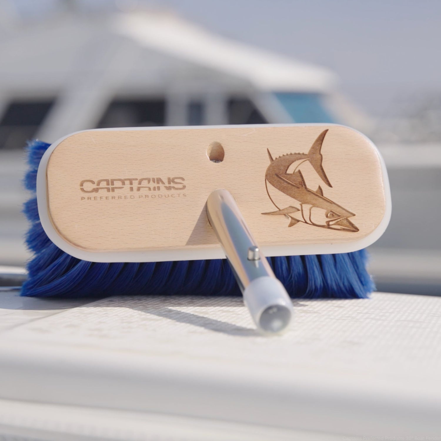 A personalized boat gift of an engraved boat brush with a fish design.