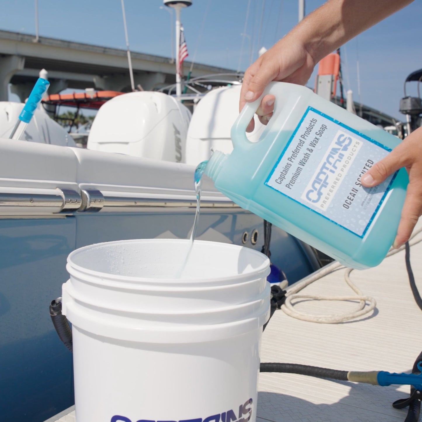 Pouring a gallon of boat soap into a bucket from Captains Preferred Products.