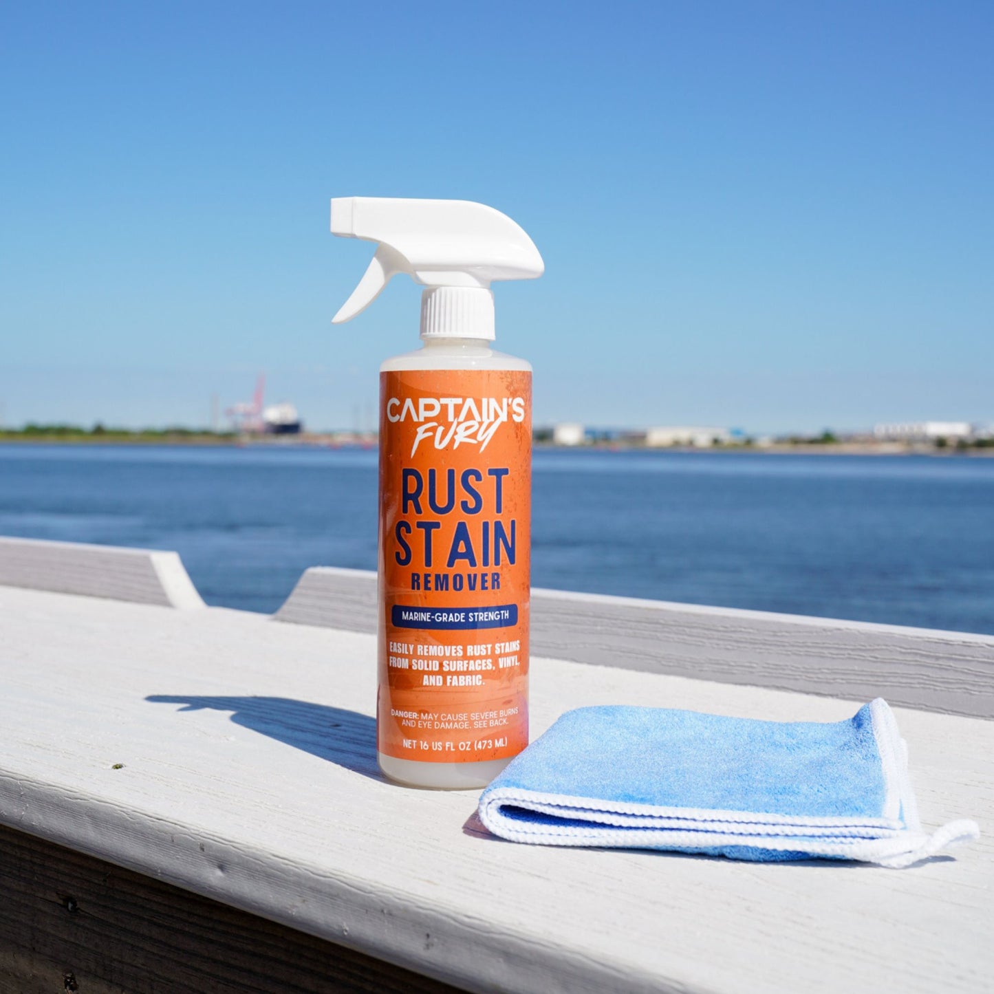 Rust remover with cleaning cloth and water in background.