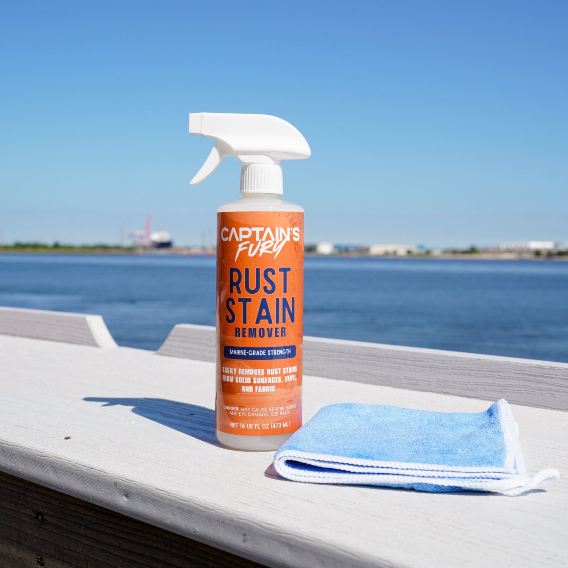 Rust remover with cleaning cloth and water in background.