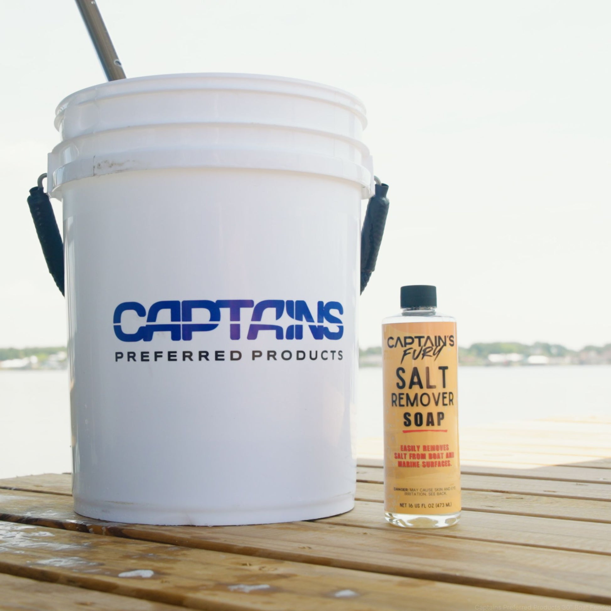 Salt remover soap with bucket on a boat dock.