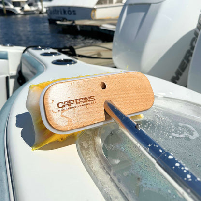 Captains' soft yellow boat brush on the side of a boat.